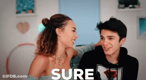 A Man And A Woman Are Looking At Each Other And The Word Sure Is On The Screen GIF
