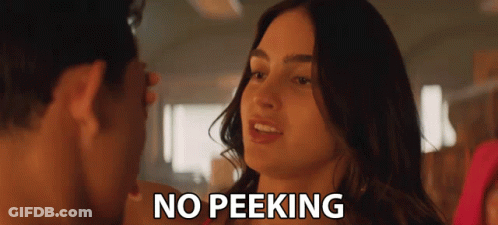 A Man And A Woman Are Looking At Each Other And The Words No Peeking Are Visible GIF