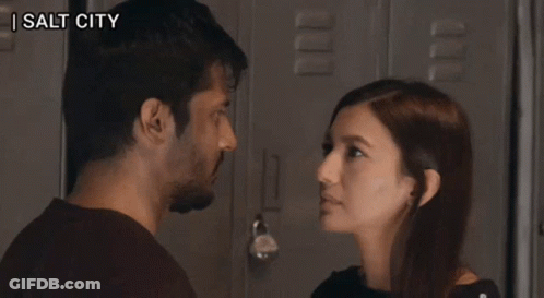 A Man And A Woman Are Looking At Each Other And The Words Zip It Up Are Visible GIF