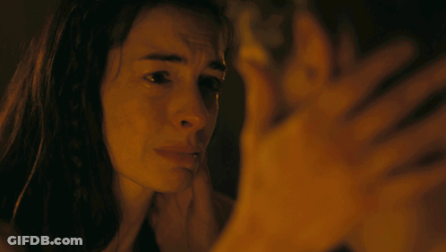 A Man And A Woman Are Looking At Each Other GIF