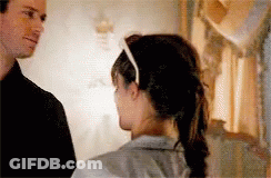 A Man And A Woman Are Looking At Each Other . GIF