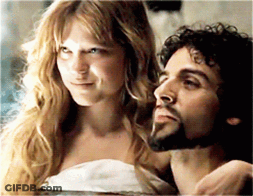A Man And A Woman Are Looking At Each Other GIF