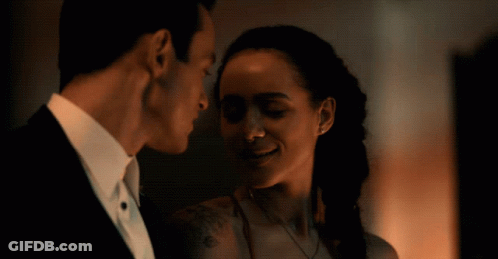 A Man And A Woman Are Looking At Each Other GIF