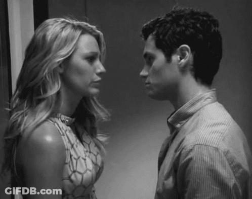 A Man And A Woman Are Looking At Each Other . GIF