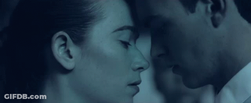 A Man And A Woman Are Looking At Each Other GIF