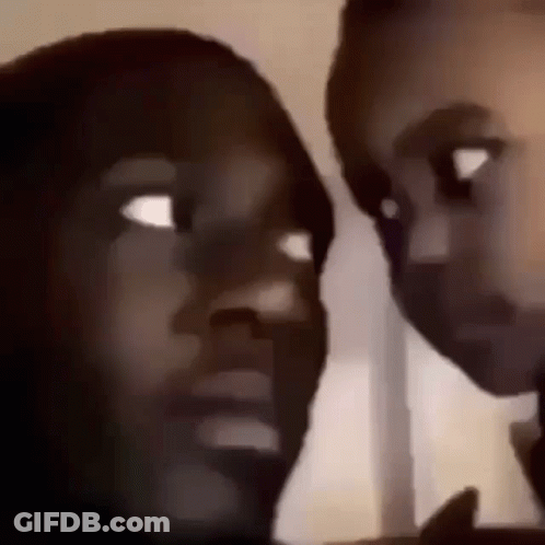 A Man And A Woman Are Looking At Each Other In A Blurry Photo . GIF