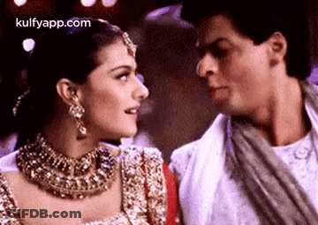 A Man And A Woman Are Looking At Each Other In A Close Up . GIF