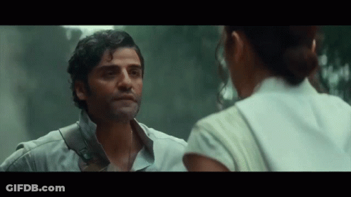 A Man And A Woman Are Looking At Each Other In A Movie . GIF