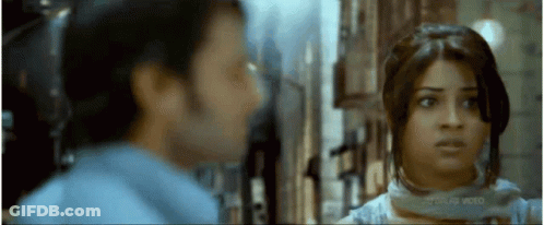 A Man And A Woman Are Looking At Each Other In A Movie Screen Shot GIF