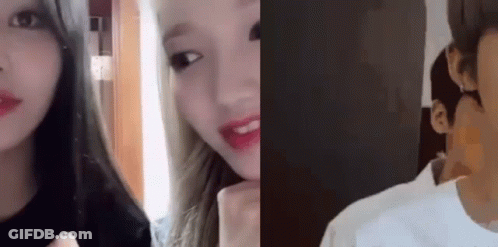 A Man And A Woman Are Looking At Each Other In A Room . GIF