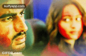 A Man And A Woman Are Looking At Each Other On A Plane . GIF