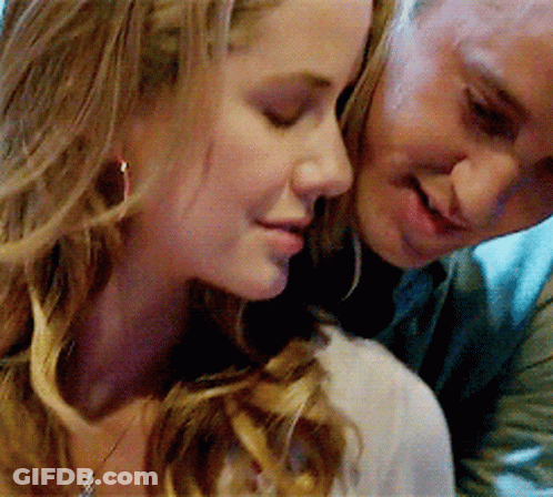 A Man And A Woman Are Looking At Each Other GIF