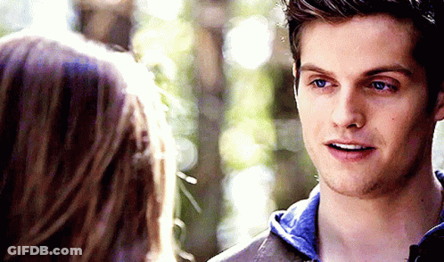A Man And A Woman Are Looking At Each Other GIF