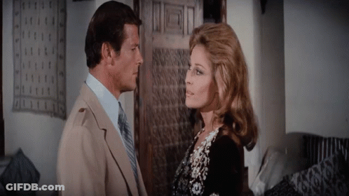 A Man And A Woman Are Looking At Each Other GIF