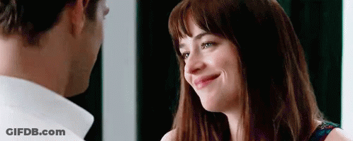 A Man And A Woman Are Looking At Each Other . The Woman Is Smiling And The Man Is Looking At Her . GIF