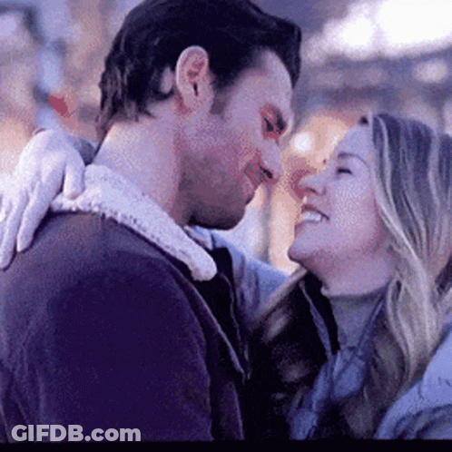 A Man And A Woman Are Looking At Each Other . GIF