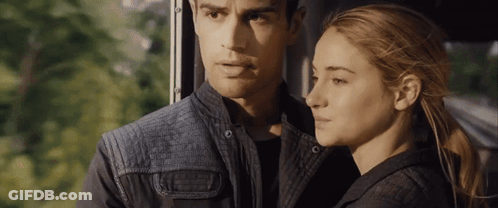 A Man And A Woman Are Looking At Each Other While Sitting Next To Each Other On A Bus . GIF