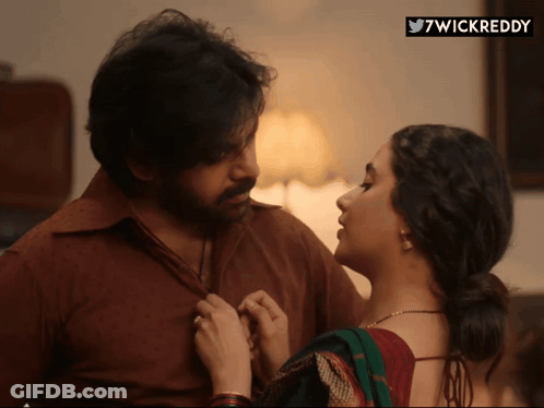 A Man And A Woman Are Looking At Each Other With A 7Wickreddy Sticker In The Corner GIF