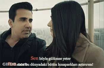 A Man And A Woman Are Looking At Each Other With A Caption In A Language Other Than English GIF