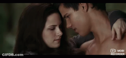 A Man And A Woman Are Looking At Each Other With A Mobi Recorder In The Bottom Right Corner GIF