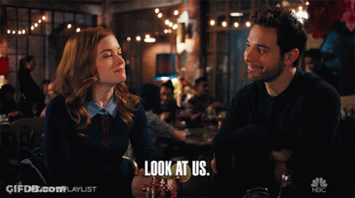 A Man And A Woman Are Looking At Each Other With The Caption Look At Us GIF