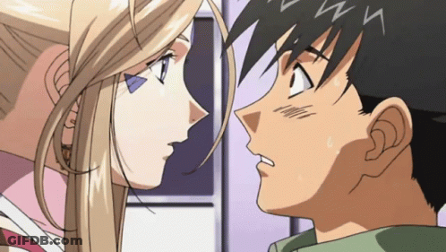 A Man And A Woman Are Looking At Each Other With The Letter N Visible On Their Foreheads GIF