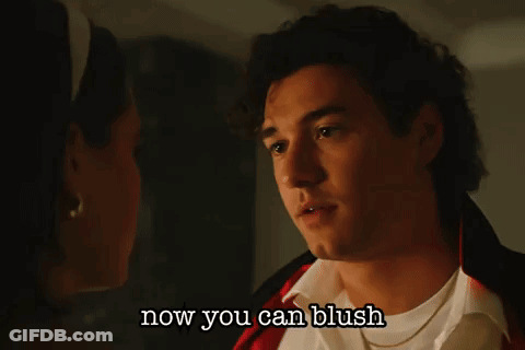 A Man And A Woman Are Looking At Each Other With The Words Now You Can Blush Below Them GIF