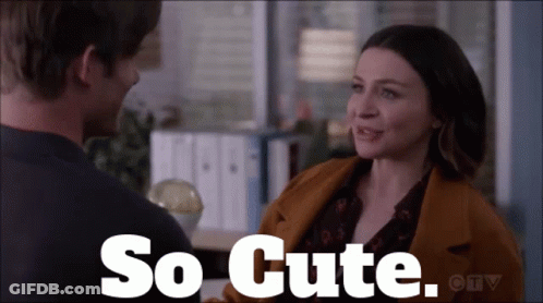 A Man And A Woman Are Looking At Each Other With The Words So Cute Written Above Them GIF