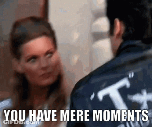 A Man And A Woman Are Looking At Each Other With The Words " You Have Mere Moments " Below Them GIF