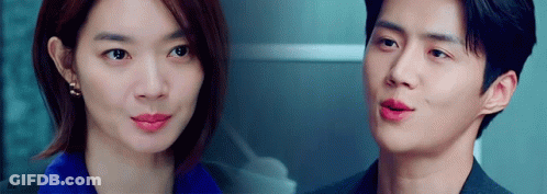 A Man And A Woman Are Looking At Each Other With Their Eyes Closed . GIF