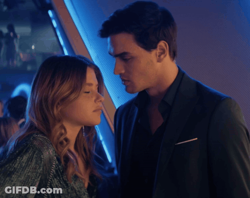 A Man And A Woman Are Looking At Each Other With Their Eyes Closed GIF