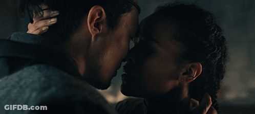 A Man And A Woman Are Looking At Each Other With Their Eyes Closed GIF