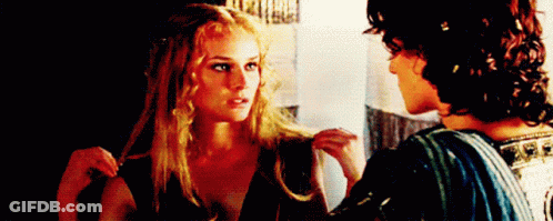 A Man And A Woman Are Looking At Each Other . GIF