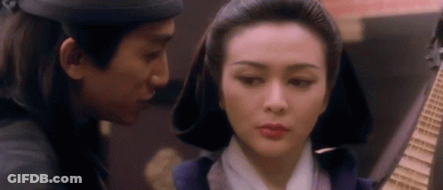 A Man And A Woman Are Looking At Each Other . GIF
