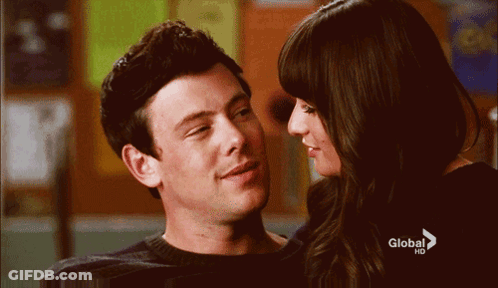 A Man And A Woman Are Looking Into Each Other 'S Eyes With A Global Hd Advertisement In The Background GIF