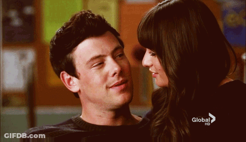 A Man And A Woman Are Looking Into Each Other 'S Eyes With A Global Hd Advertisement In The Background GIF