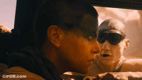 A Man And A Woman Are Looking Out A Car Window GIF