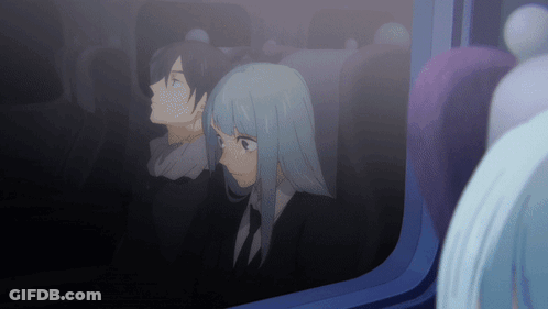 A Man And A Woman Are Looking Out A Window GIF