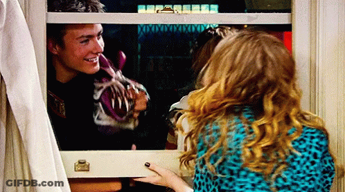 A Man And A Woman Are Looking Out A Window And The Man Is Smiling GIF