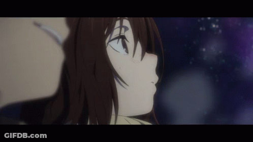 A Man And A Woman Are Looking Up At The Stars In The Night Sky . GIF