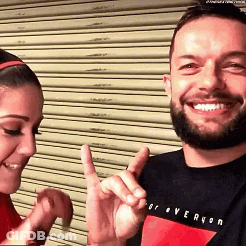 A Man And A Woman Are Making A Heart Shape With Their Hands . GIF