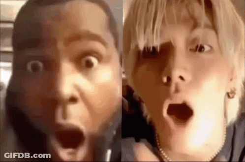 A Man And A Woman Are Making Funny Faces With Their Mouths Open . GIF
