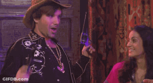 A Man And A Woman Are Making Funny Faces With Their Mouths Open GIF