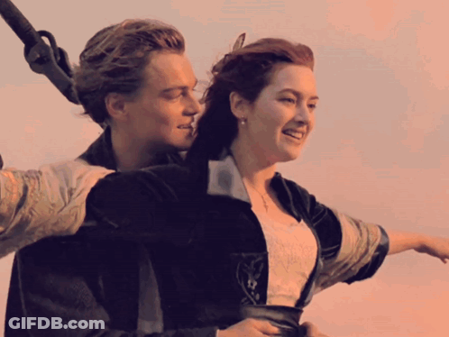 A Man And A Woman Are On A Boat And Smiling GIF