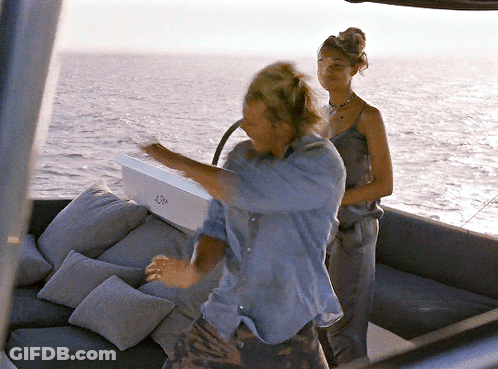 A Man And A Woman Are On A Boat With A Box That Says ' A ' On The Side GIF