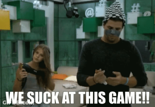 A Man And A Woman Are Playing A Video Game With The Words We Suck At This Game GIF