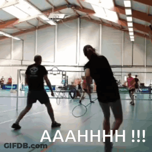 A Man And A Woman Are Playing Badminton In A Gym And The Caption Says Aaahhhh !!! GIF
