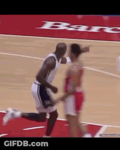 A Man And A Woman Are Playing Basketball On A Court With A Bar Advertisement In The Background .. GIF