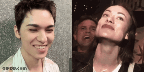 A Man And A Woman Are Posing For A Picture And The Man Is Smiling GIF