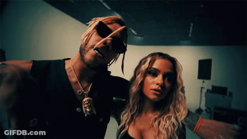 A Man And A Woman Are Posing For A Picture And The Man Is Wearing Sunglasses GIF